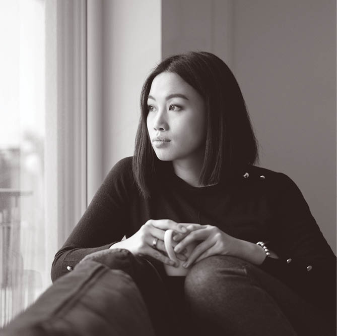 Woman enjoying coffee by the window at home